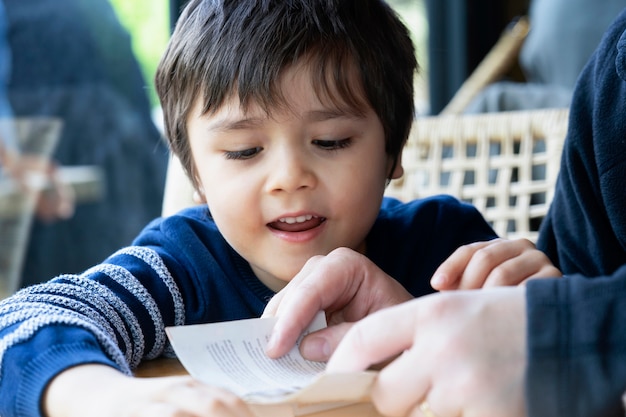 Colpo ritagliato di padre che legge un libro a suo figlio