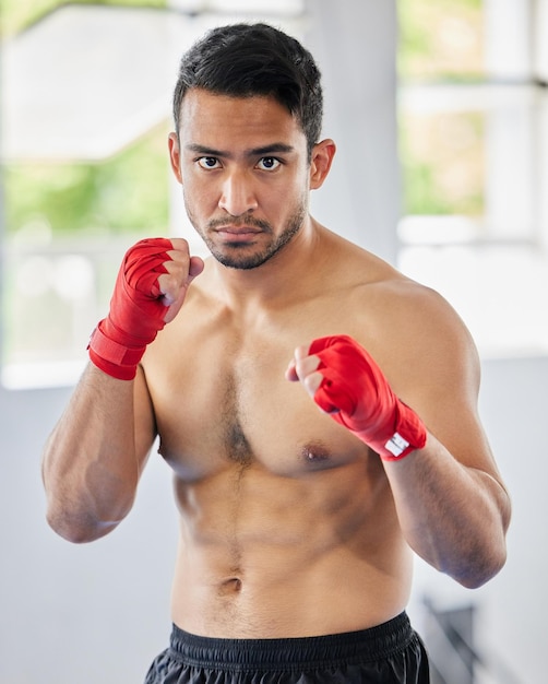 Combatti il pugno e l'atleta di kickboxing uomo che sembra serio arrabbiato e pronto per l'allenamento e la competizione di arti marziali Sport asiatici o ritratto del modello di Muay thai per la sessione di allenamento in palestra ftness