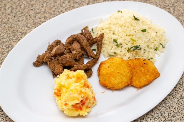 Comida dominicana en plato blanco de arroz, pollo.