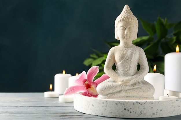 Composizione con buddha e candele sul tavolo di legno. Concetto Zen