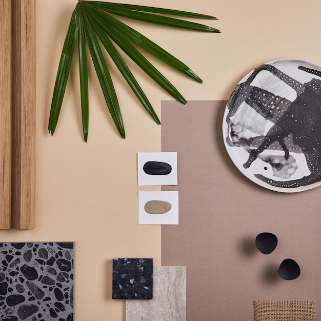 Composizione creativa piatta del moodboard di interior designer e architetto Campioni di tessuti e vernici Pannelli lamellari e piastrelle di lastrico Tavolozza dei colori beige nero e verde Spazio di copia Modello