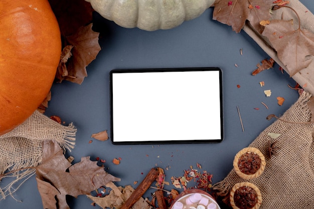 Composizione della decorazione di halloween con zucca e tablet con spazio di copia su sfondo grigio. tradizione e concetto di celebrazione halloween immagine generata digitalmente.