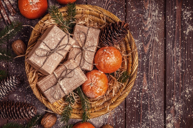 Composizione in Natale con mandarini, scatole regalo, coni