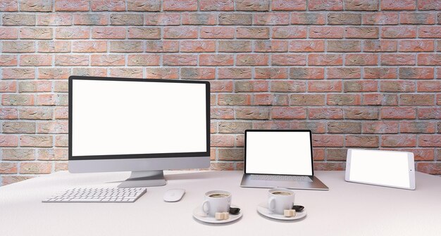 Computer e laptop Mockup sulla scrivania in ufficio con sfondo di muro di mattoni rossi