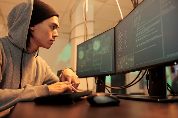 computer fraud, electronic data stealing, hacker threat, criminal coding malware, asian man hacking system. internet thief cracking online server password, programming spyware