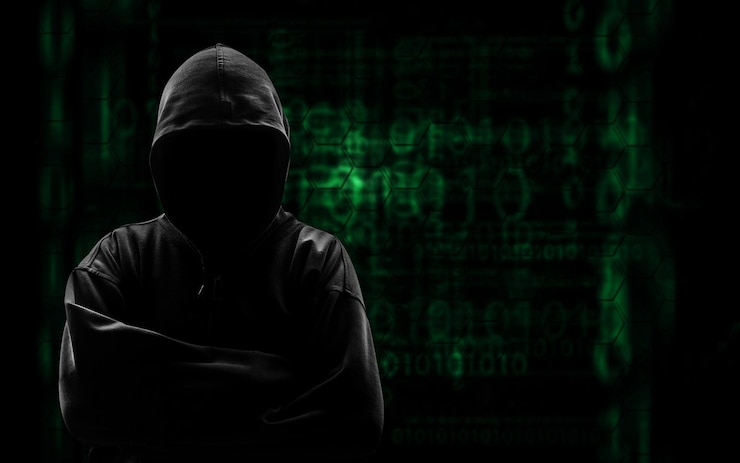 Photo computer hacker in hooded shirt against interface