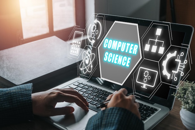 Computer science concept Person working on laptop computer with computer science icon on virtual screen