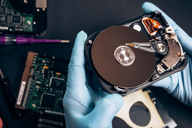 Computer service engineer technician workplace repairing fixing disassembled HDD hard drive data