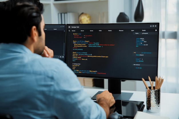 Concentrating in smart it developer working coding on two pc screen surmise