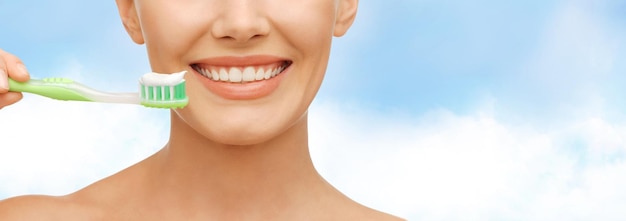 concetto di bellezza e salute dentale - bella donna con spazzolino da denti verde