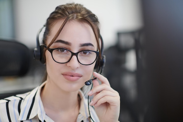 concetto di business e tecnologia - operatore femminile di helpline con le cuffie nel call center Donna d'affari con le cuffie che lavora in un call center