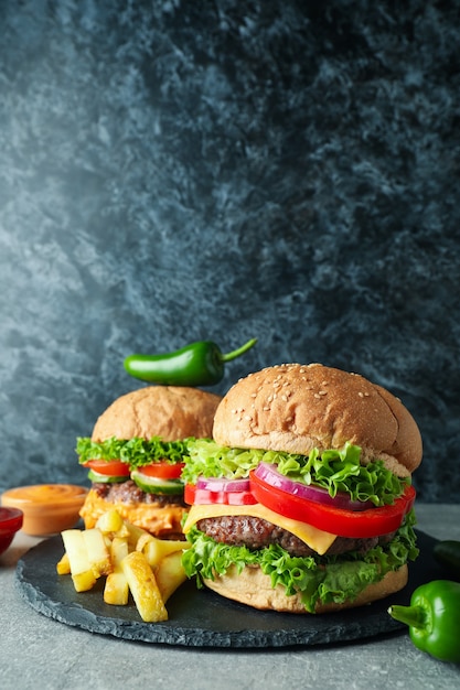 Concetto di cibo gustoso con deliziosi hamburger