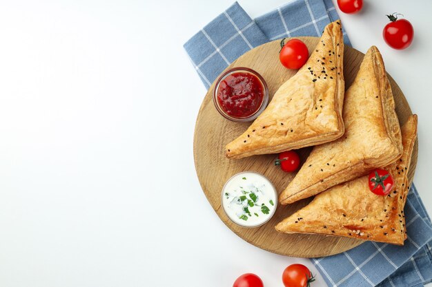 Concetto di cibo gustoso con samsa su sfondo bianco