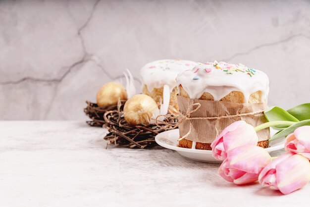 Concetto di pasqua. Dolci pasquali smaltati con tulipani e uova colorate vista frontale