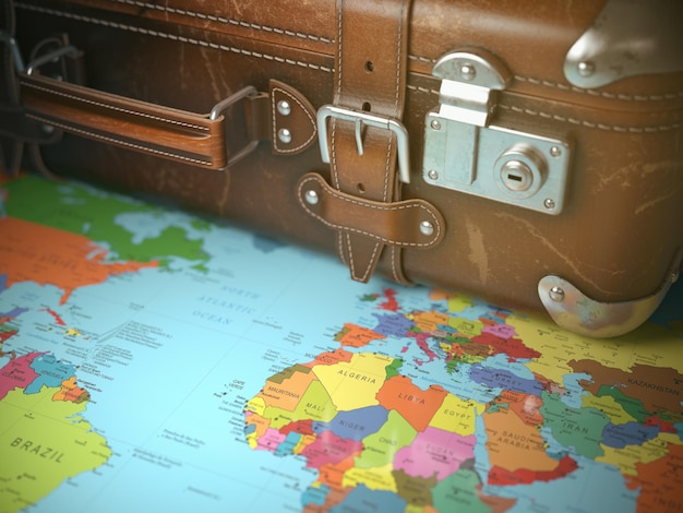 Concetto di sfondo per viaggi e vacanze Valigia vintage sulla mappa del mondo