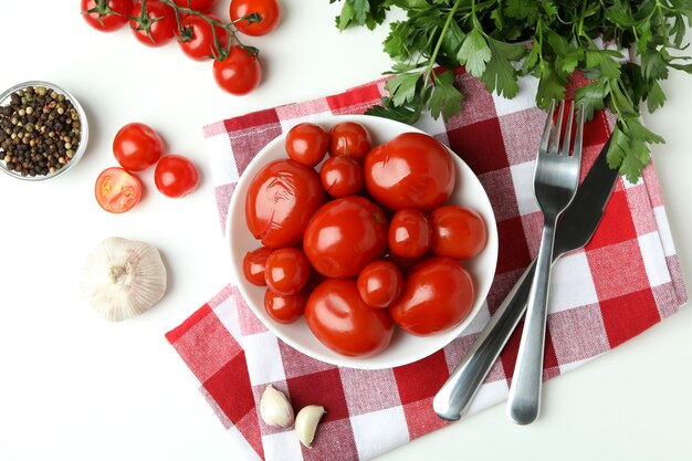 Concetto di sottaceti con pomodori sul tavolo bianco