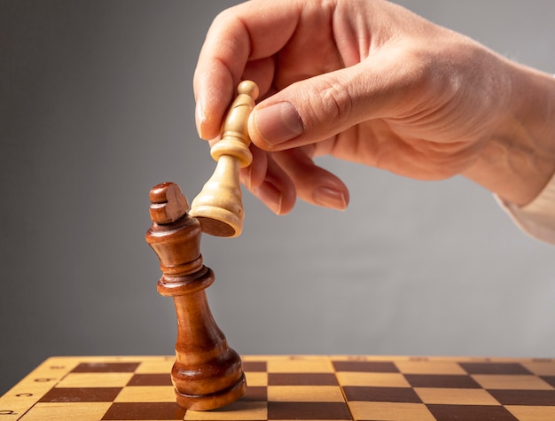 Concetto di strategia aziendale. Cavaliere che fa l'ultimo passo per fare scacco matto negli scacchi, cadendo re.