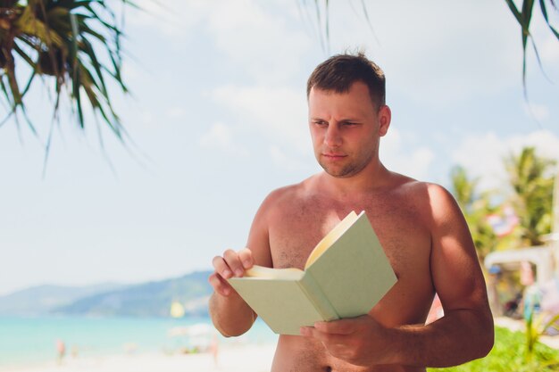 Concetto di vacanze estive. Infradito su una spiaggia sabbiosa dell'oceano.