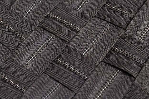 Confeziona un sacco di strisce di cerniere in metallo nero con motivo a cursori per la lavorazione del cuoio su misura