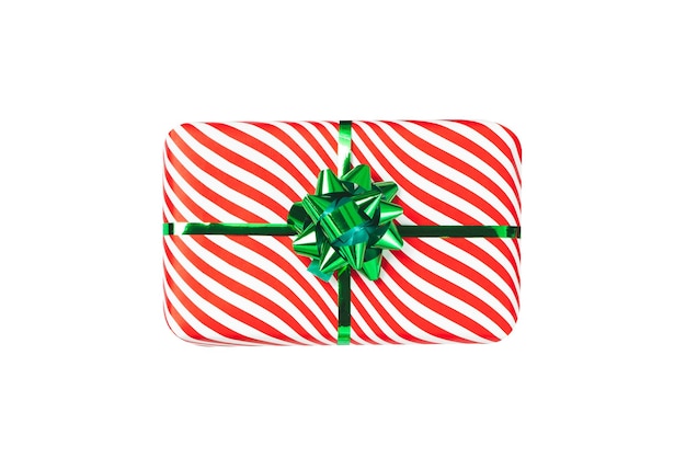 Confezione regalo rossa avvolta con oggetto fiocco nastro verde lucido isolato su sfondo bianco Una vista dall'alto dell'involucro a strisce per le vacanze Decorazione del nuovo anno del regalo di Natale