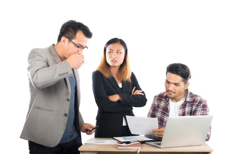 Photo confused businesswoman looking at male colleague drinking coffee during meeting against white background