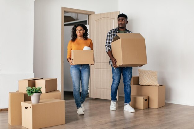 Coniugi neri scontenti che entrano nella nuova casa scontenti dei lavori di ristrutturazione