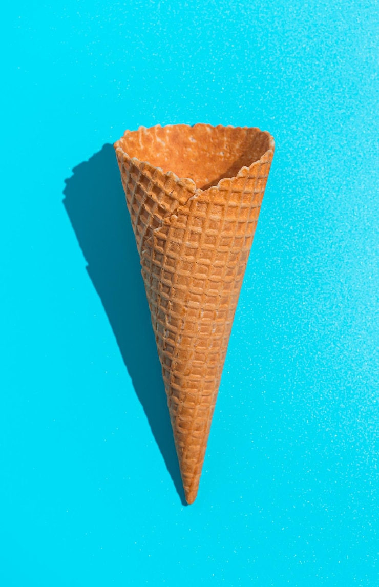 Foto cono gelato waffle su sfondo blu vista dall'alto verticale