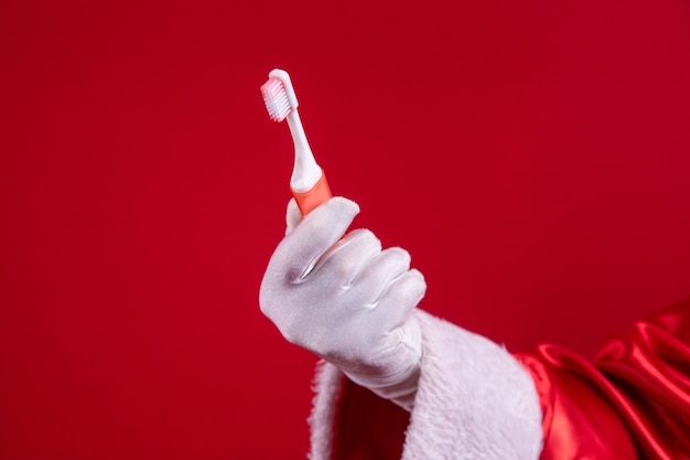 Consiglio di Babbo Natale: lavati bene i denti tutti i giorni! Su sfondo rosso