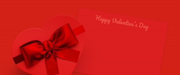 Contenitore di regalo rosso a forma di cuore e cartolina d'auguri rossa