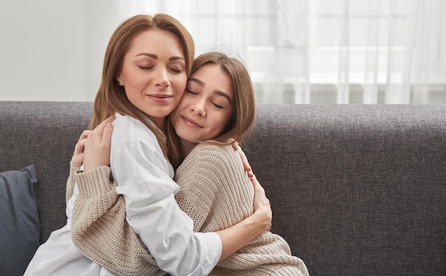 Contenta madre e figlia che si abbracciano a casa