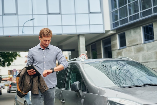 Controllo dell'ora Uomo che fa una passeggiata all'aperto in città durante il giorno