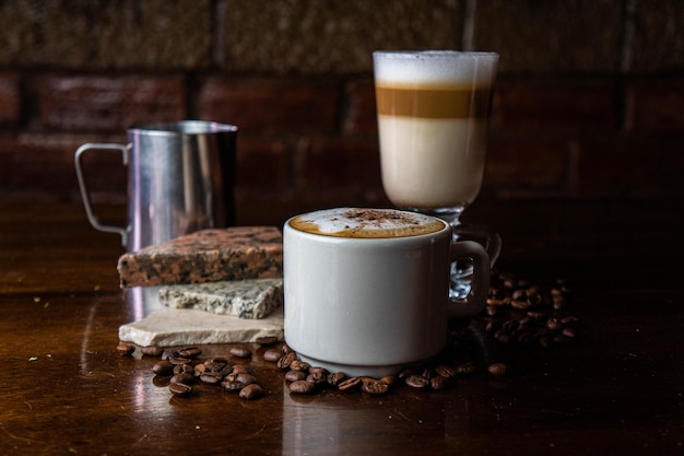 Coppa con schiume e scintille di cacao e chicchi di caffè e altri contenitori