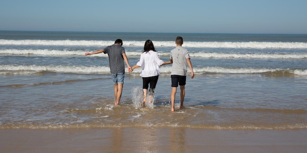 coppia al mare sulla spiaggia con il loro ragazzo adolescente