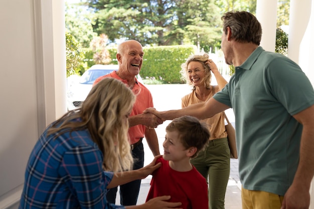 Coppia caucasica che accoglie la famiglia all'ingresso di casa. concetto di famiglia, amore e unione, inalterato.