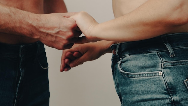 Coppia che si tiene per mano a metà sezione coppia eterosessuale in jeans blu che si tengono per mano