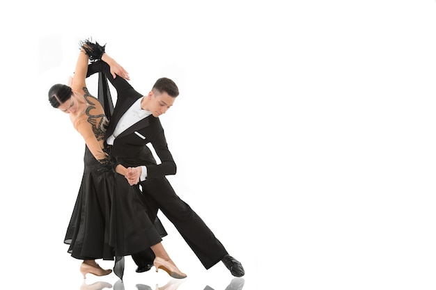 Coppia di ballo da sala in una posa di ballo isolata su priorità bassa bianca. ballerini professionisti sensuali che ballano valzer, tango