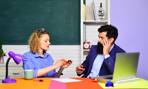 Coppia di studenti che si preparano per il test o l'esame. Studenti che studiano in classe. Giovani insegnanti seri. Studenti delle scuole. Concetto di formazione per studenti e tutoraggio. Fiduciosi giovani insegnanti di sesso femminile e maschile.