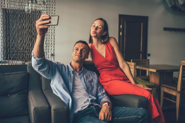 Coppia divertirsi prendendo selfie in poltrone