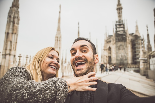 Coppia felice divertirsi con selfie sulla cima della cattedrale