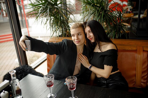 Coppia lesbica ad un appuntamento in un ristorante bevendo vino