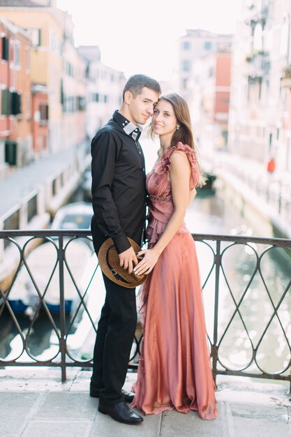 Coppia romantica a Venezia. Giovani belle coppie che stanno sul ponte del canale e dell'abbracciare di Venezia. Italia, Europa