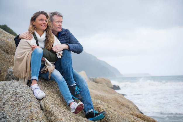 Coppia seduta sulle rocce e godersi la vista