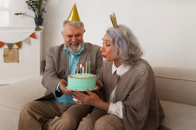 Coppia senior del colpo medio che celebra con la torta