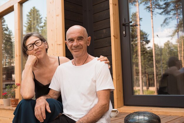 Coppia senior romantica innamorata seduta sulla terrazza di casa