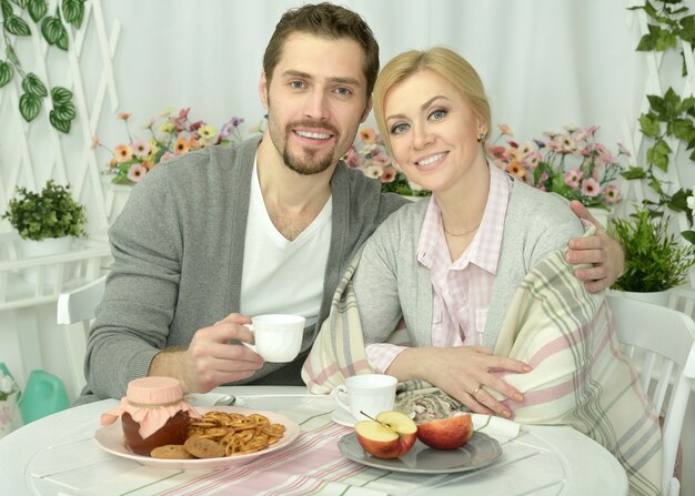 Coppia sorridente a tavola con caffè e cibo