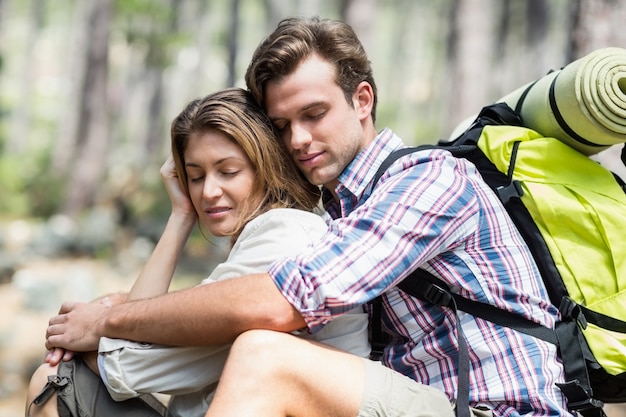 Coppie che abbracciano e che si rilassano nella foresta