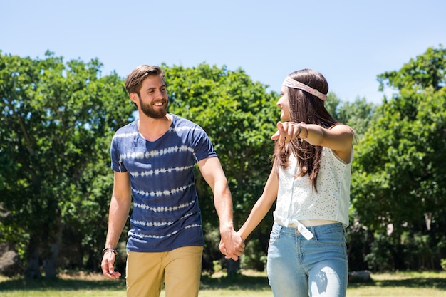 Coppie dei pantaloni a vita bassa che camminano nel parco