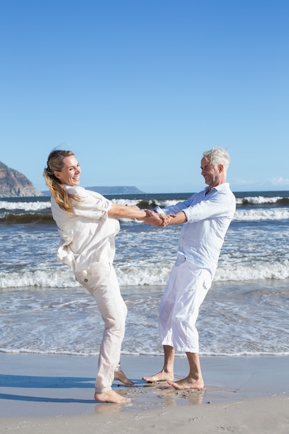 Coppie sorridenti che filano sulla spiaggia