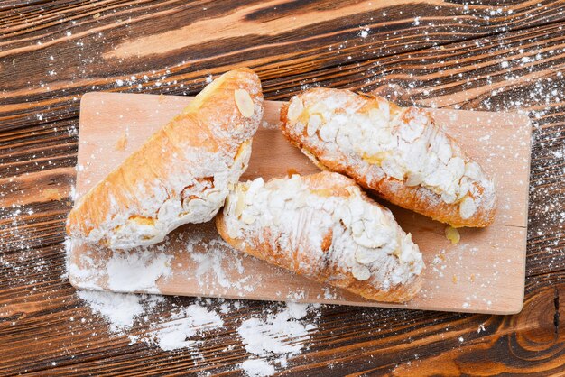 Cornetti con mandorle e tè su un tavolo di legno