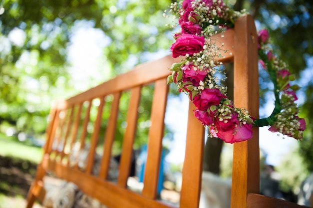 Corona di fiori su una panca di legno al parco